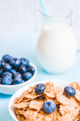 healthy breakfast, cornflakes blueberry and milk, nuts, almond with text space close-up