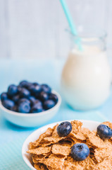 healthy breakfast, cornflakes blueberry and milk, nuts, almond with text space close-up