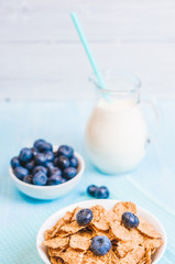 healthy breakfast, cornflakes blueberry and milk, nuts, almond with text space close-up
