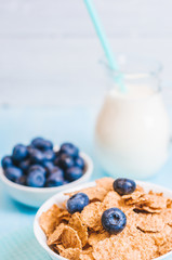 healthy breakfast, cornflakes blueberry and milk, nuts, almond with text space close-up