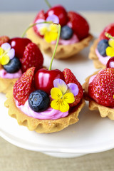 Cupcakes with fresh fruits and edible flowers.