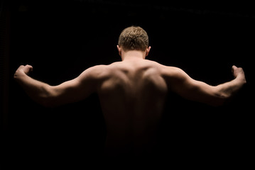 Fototapeta na wymiar Back view portrait of a man with muscular body