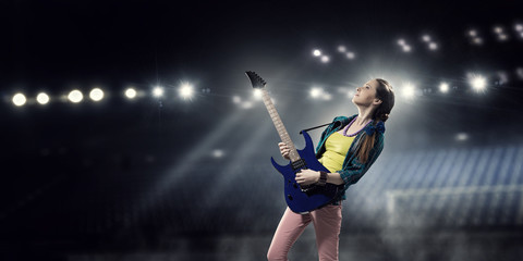 Fototapeta na wymiar Female rock guitarist . Mixed media