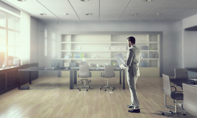 Businessman in modern office  . Mixed media