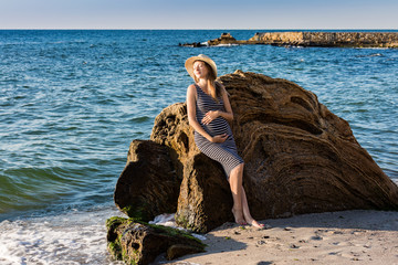 Pregnant woman on vacation near sea shore