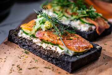 Charcoal Bread Smoked Salmon Sandwiches on wood board