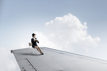 She is flying high . Mixed media