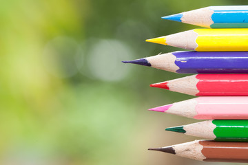 Color pencils isolated on nature background close up