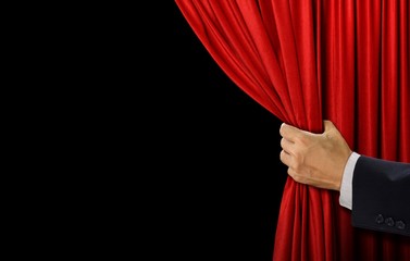 Hand open stage red curtain on black background - obrazy, fototapety, plakaty