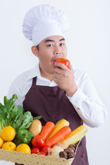 Portrait of a chef holding fruit and vegetable