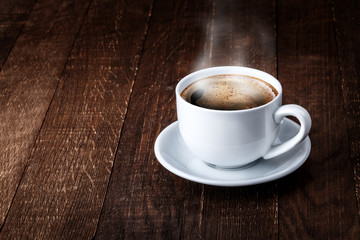 white mug of coffee on a wooden background