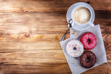 Obraz na płótnie Canvas white mug grain coffee and donuts on a wooden background
