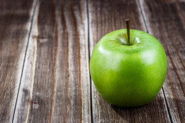 green apple fruit on a wooden background