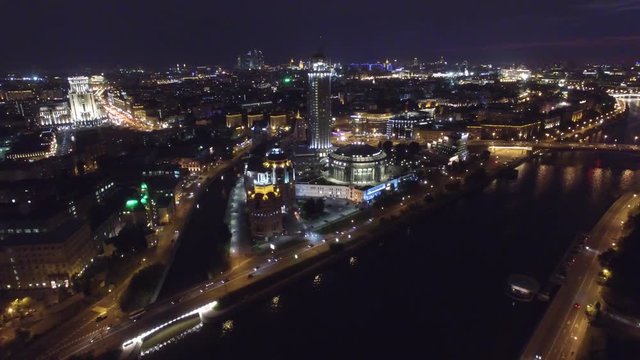 Night aerial flight over center of Moscow. House of music hall. Modern Glass buildings. Night road traffic. Close approach. UAV quadcopter drone 4K footage.