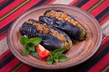 Baked eggplant stuffed with onions, cherry plums and walnuts