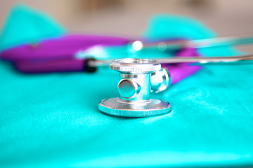 stethoscope shaping  heart and  clipboard on  medical uniform, closeup