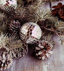Christmas balls with fir branches and glasses of champagne
