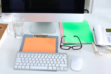 Designer working desk with computer and paperwork