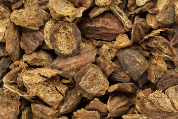 Organic cracked Chebulic Myrobalan or Choti Harad (Terminalia chebula). Macro closeup background texture. Top View.
