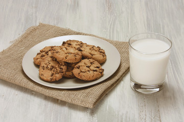Photo of chocolate chips cookies with glass of milk