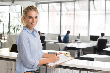 Businesswoman writing notes