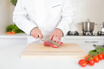 Male chef preparing meat stakes