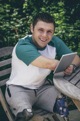 Obraz premium Using Digital Tablet in the Garden
