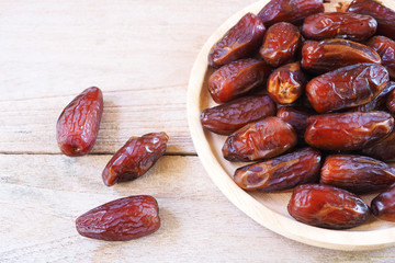 Top view of pile of dried date fruit on a wooden table.