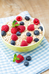 Oatmeal porridge with berries. Raspberries and blueberries.