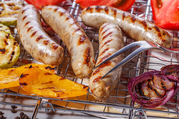 Cooked sausages on the grill grate.