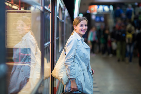 Elegant, smart, young woman taking the metro/subway