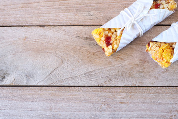 Top view of healthy cereal bars on a wooden table.