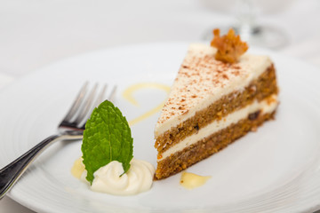 Slice of Carrot Cake with Fork and Mint Leaf