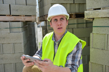 Foreman using digital tablet on construction site