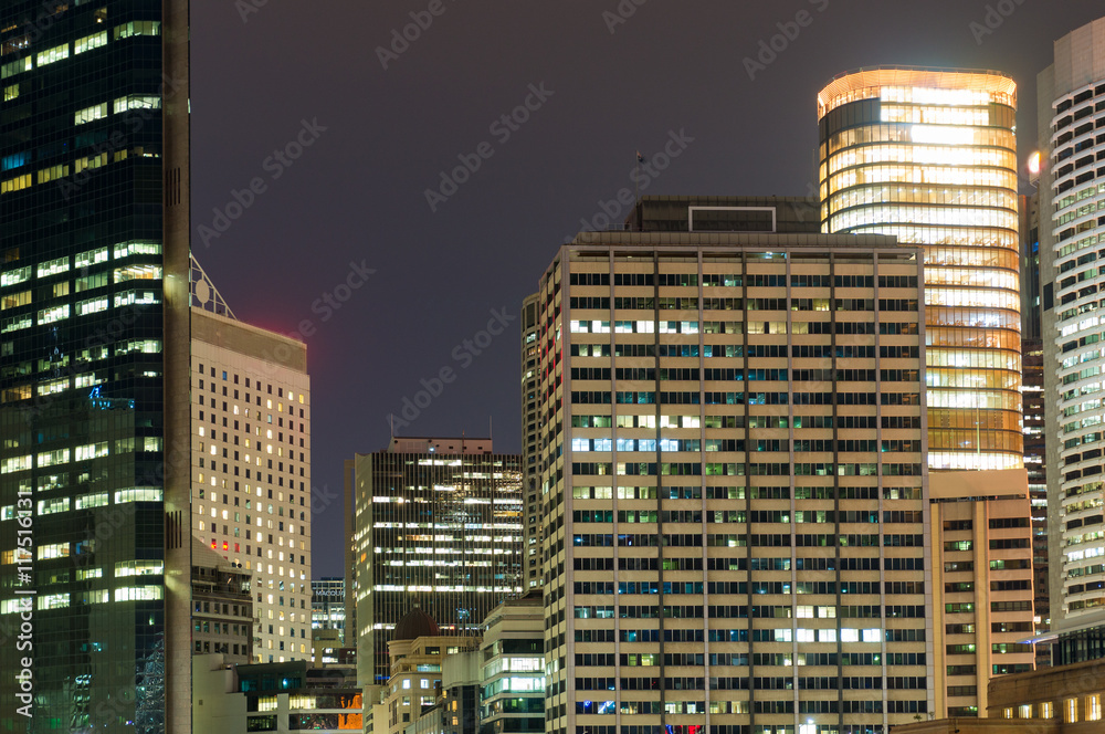 Sticker Modern cityscape at night background. Skyscrapers of Sydney downtown at dusk. Copy space, long exposure