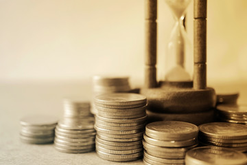 coin money and hourglass for about time of finance concept

