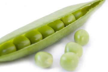 fresh green peas on white background