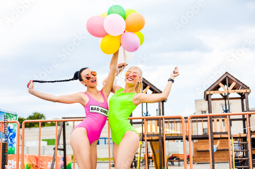 Two Beautiful Cute Sexy Hipster Girls In Pink And Light Green Bikini
