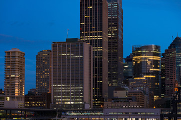 Modern cityscape at evening background. Skyscrapers of Sydney downtown at blue hour. Copy space, long exposure