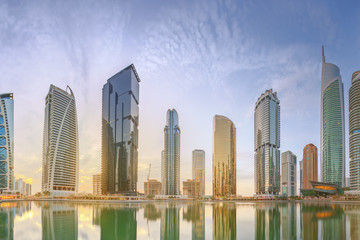 Panoramic view of Business bay and Lake Tower, reflection in a river, Dubai UAE
