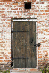 Old door in the stone walls of the village houses. Excellent background.