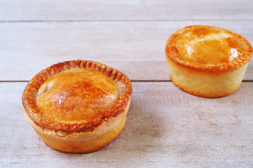 Traditional English Pork Pie on a wooden table.