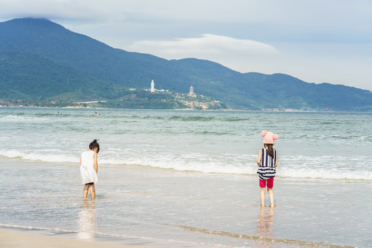 Small girls at the China Beach of Danang in Vietnam