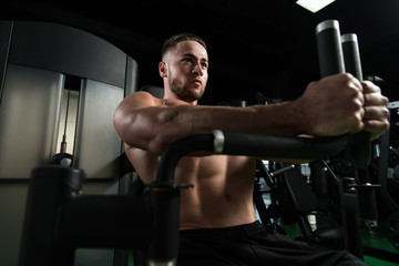 Fototapeta na wymiar Chest Exercise On Machine In Gym