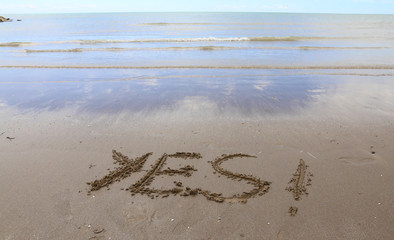 YES written on the beach