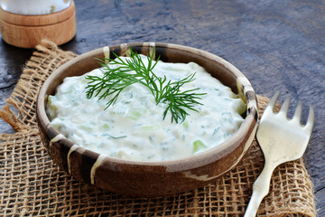 Tzatziki Greek yogurt cucumber sauce in rustic stoneware bowl
