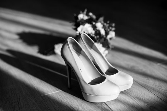 The wedding bouquet stands near shoes
