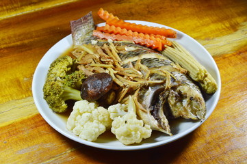 steamed mango fish with slice ginger and vegetable in soy sauce on dish