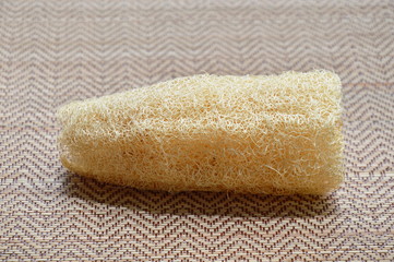 Fototapeta premium loofah body scrub on bamboo mat