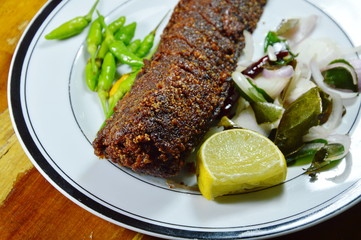 deep fried catfish with herb and lemon on plate